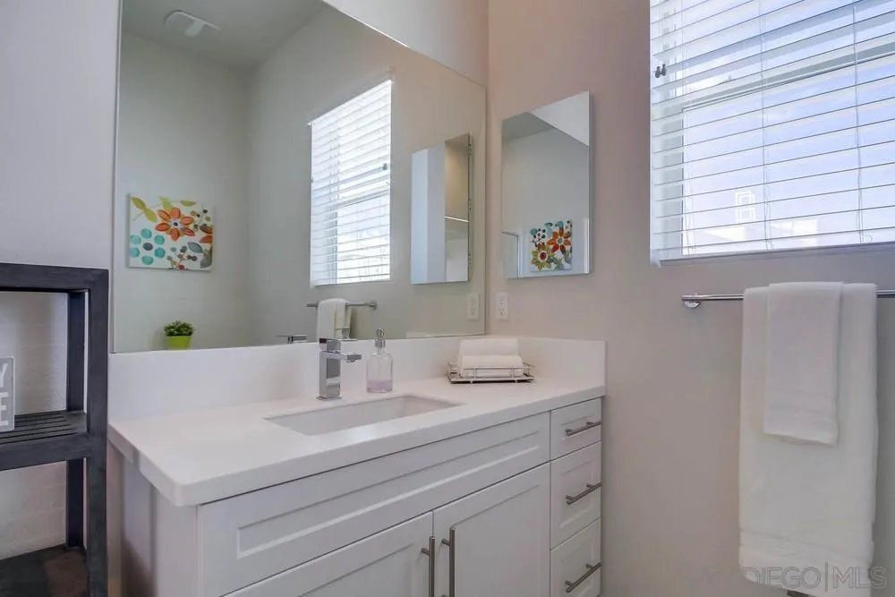 2035 Bravo Loop, Unit 6 Chula Vista, CA 91915 - Photo 29 of 39 a bathroom with a sink and a mirror