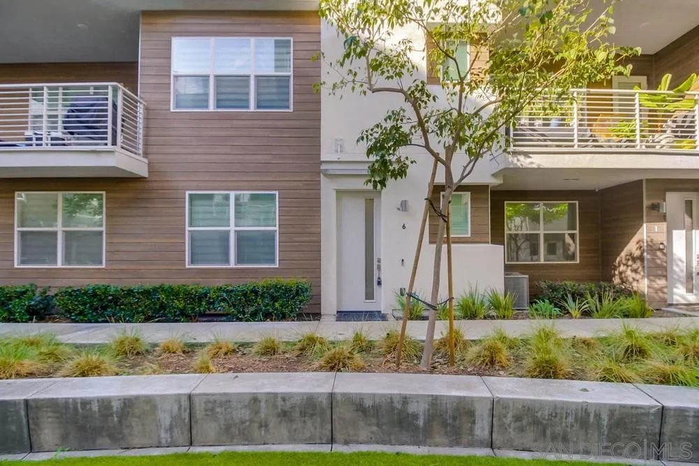 2035 Bravo Loop, Unit 6 Chula Vista, CA 91915 - Photo 3 of 39 a front view of a house with a yard and outdoor seating