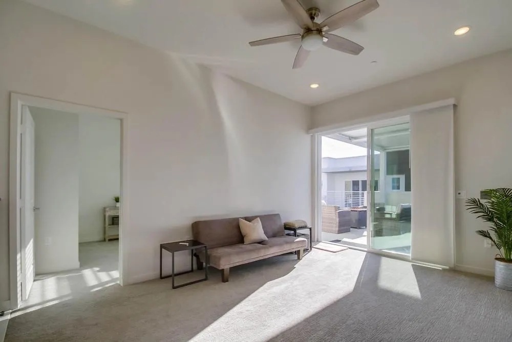 2035 Bravo Loop, Unit 6 Chula Vista, CA 91915 - Photo 31 of 39 a living room with furniture and a chandelier