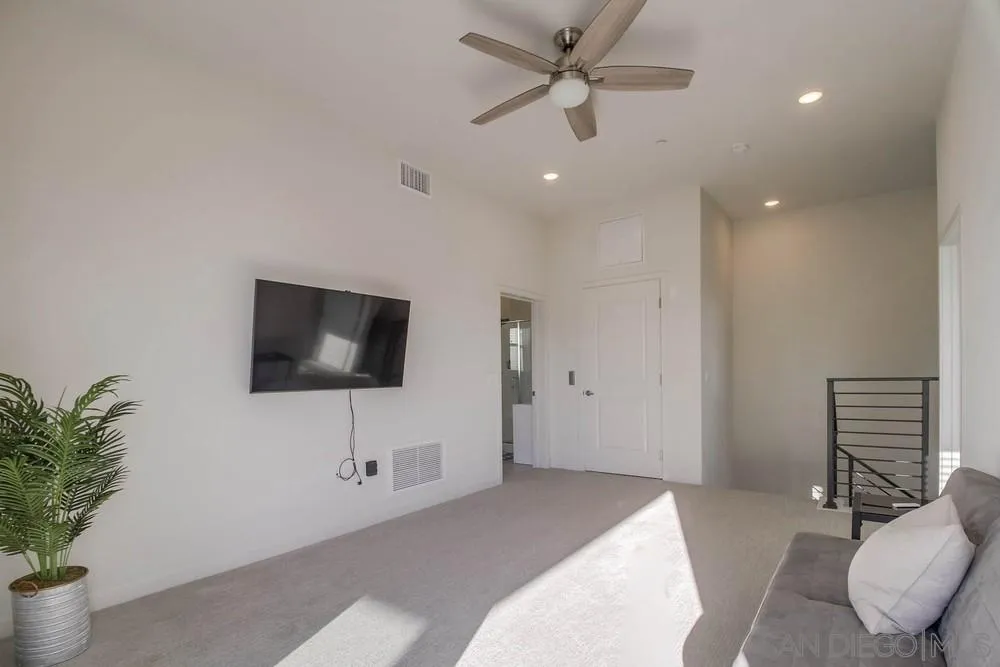 2035 Bravo Loop, Unit 6 Chula Vista, CA 91915 - Photo 32 of 39 a bedroom with a bed and a flat screen tv