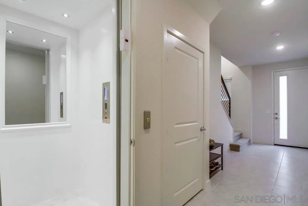 2035 Bravo Loop, Unit 6 Chula Vista, CA 91915 - Photo 5 of 39 hallway with stairs and wooden floor