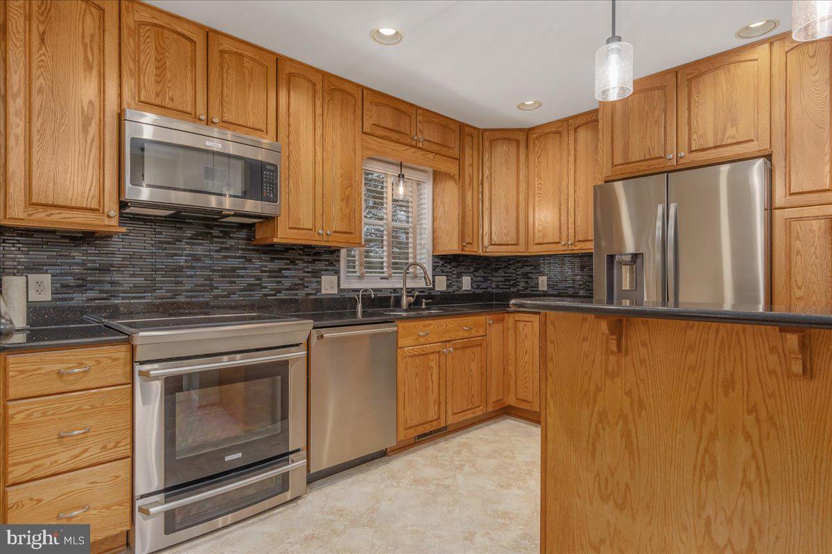 11 Funkstown Road Hagerstown, MD 21740 - Photo 11 of 39 a kitchen with granite countertop wooden cabinets stainless steel appliances and a window