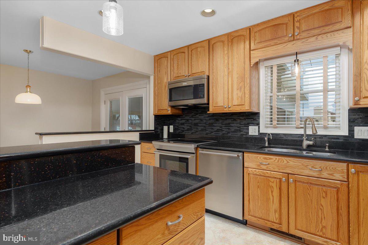 11 Funkstown Road Hagerstown, MD 21740 - Photo 14 of 39 a kitchen with granite countertop cabinets stainless steel appliances a sink and a window
