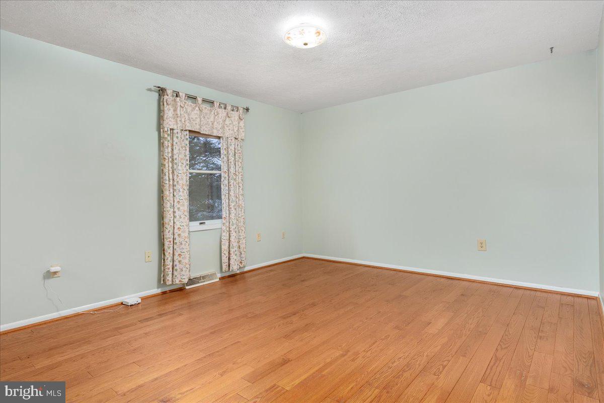 11 Funkstown Road Hagerstown, MD 21740 - Photo 16 of 39 an empty room with wooden floor and windows