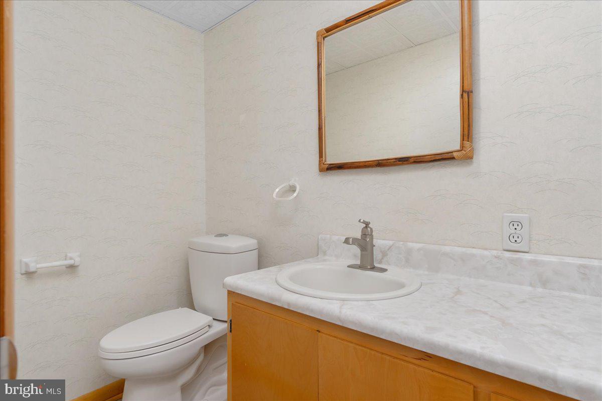 11 Funkstown Road Hagerstown, MD 21740 - Photo 29 of 39 a bathroom with a sink a toilet and mirror