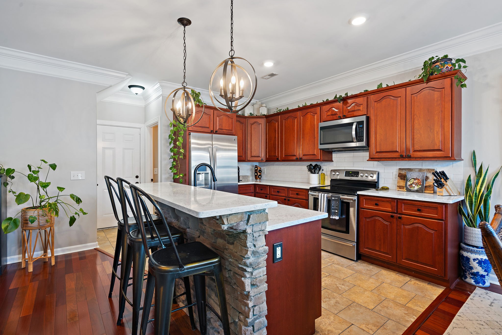 2521 Pennington Bend Road, Unit 214 Nashville, TN 37214 - Photo 7 of 25 a open kitchen with stainless steel appliances granite countertop a stove top oven a refrigerator a sink dishwasher a dining table and chairs with wooden floor