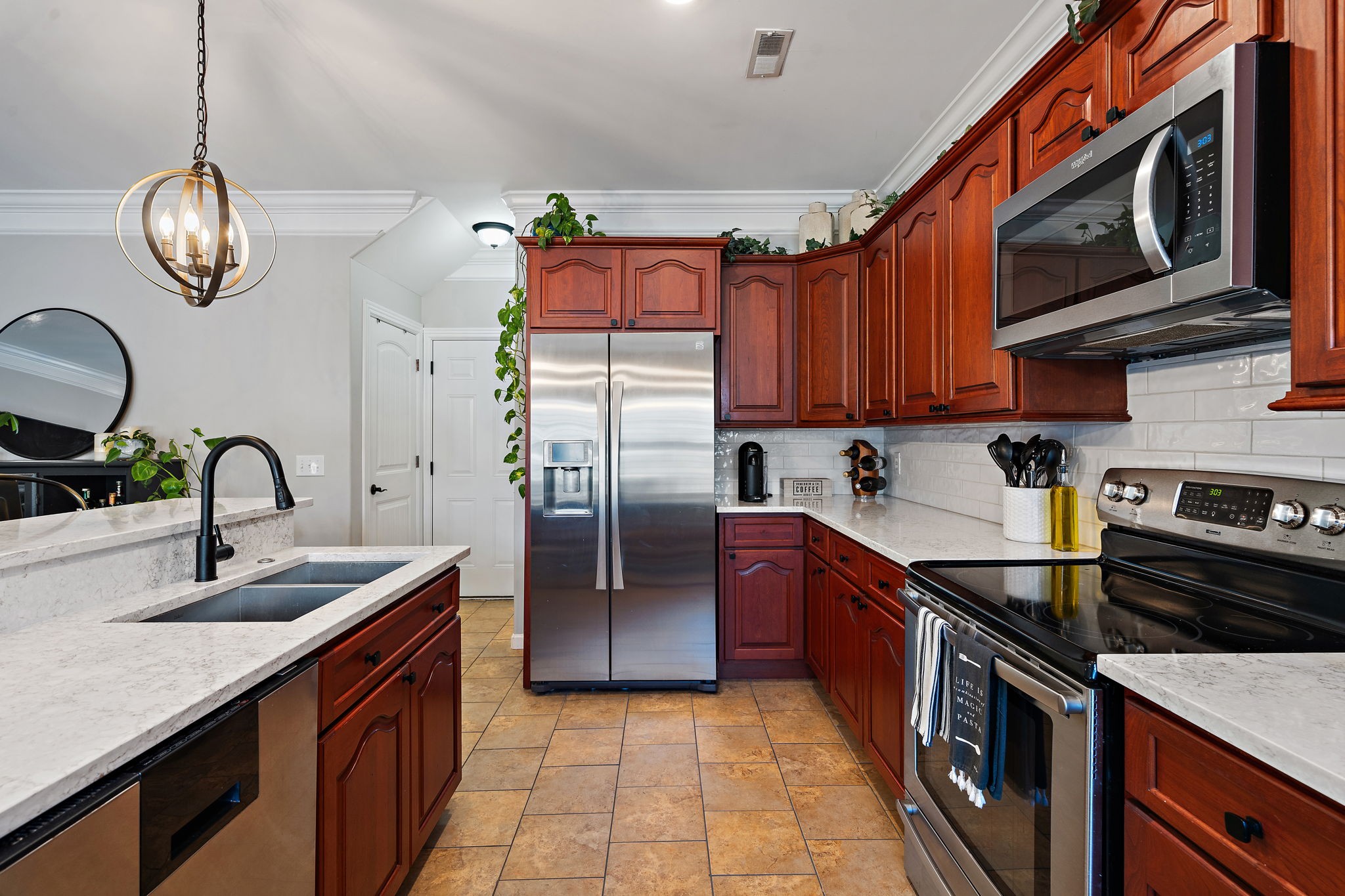 2521 Pennington Bend Road, Unit 214 Nashville, TN 37214 - Photo 10 of 25 a kitchen with stainless steel appliances granite countertop a sink a stove top oven a refrigerator cabinets and a window