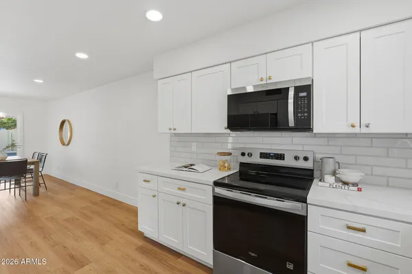 a kitchen with stainless steel appliances a stove microwave and cabinets