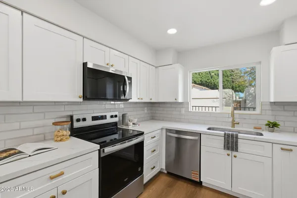 a kitchen with a sink stove and microwave