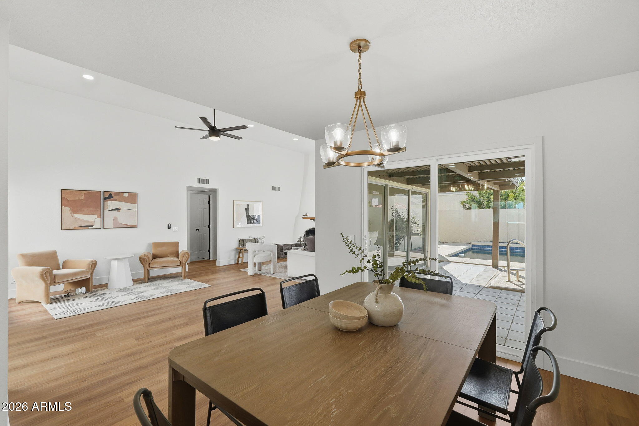 3011 West Sierra Street Phoenix, AZ 85029 - Photo 17 of 35 a view of a dining room and livingroom with furniture wooden floor a chandelier