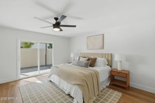 a bedroom with a bed and a ceiling fan