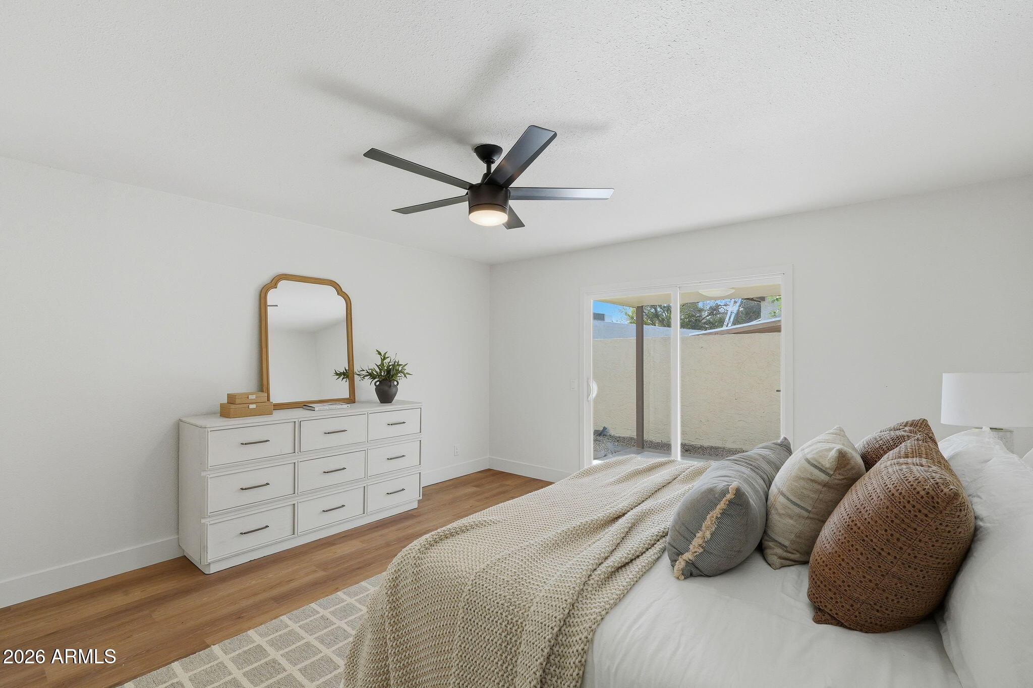 3011 West Sierra Street Phoenix, AZ 85029 - Photo 19 of 35 a bedroom with a bed and a dresser