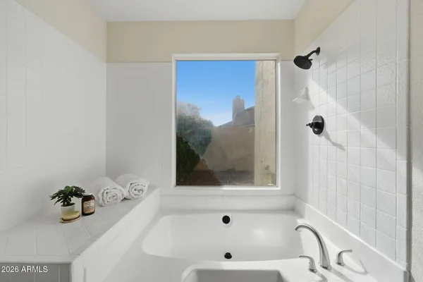 a bathroom with a tub and a shower