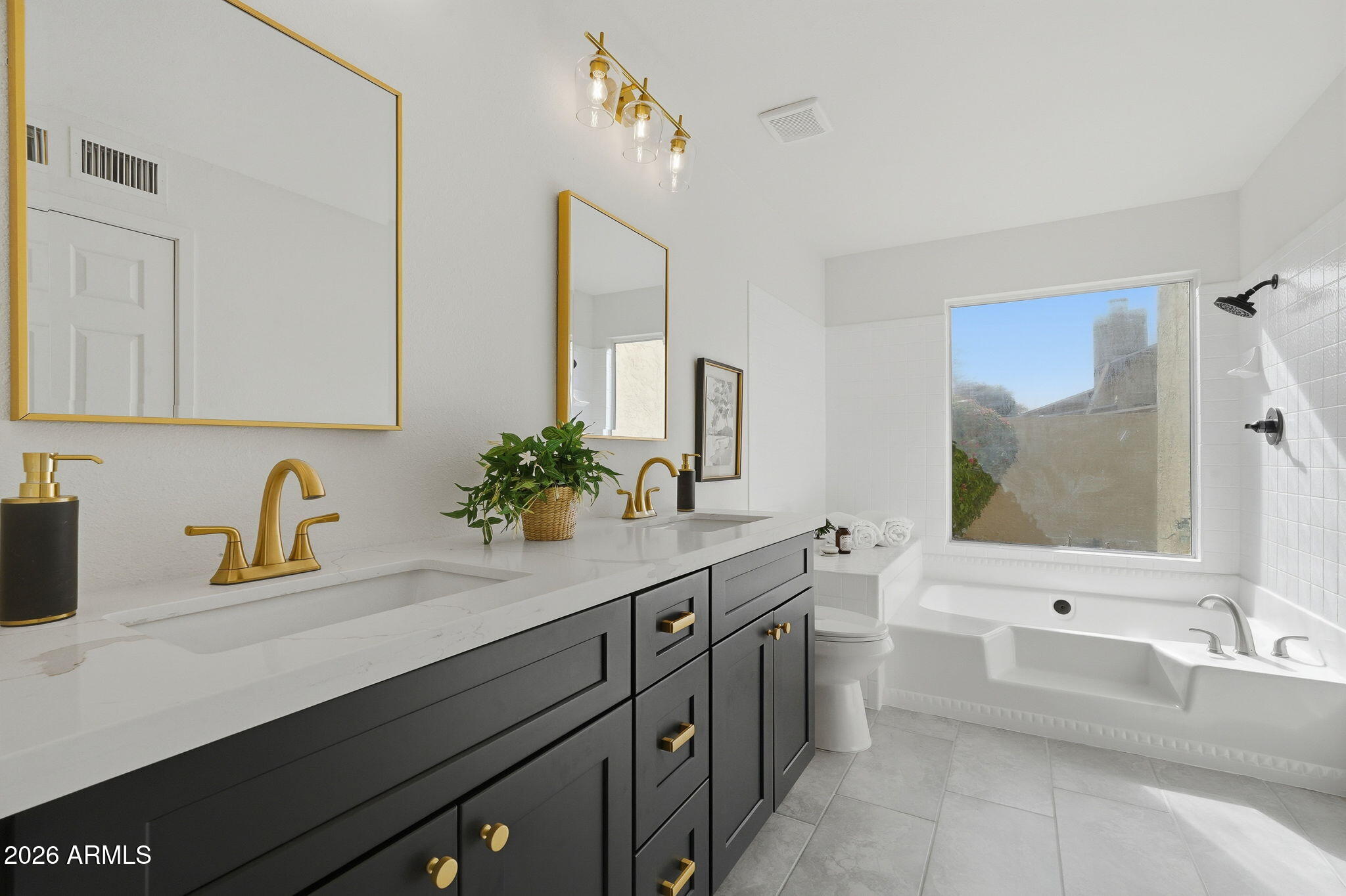 3011 West Sierra Street Phoenix, AZ 85029 - Photo 24 of 35 a bathroom with a tub a sink and mirror