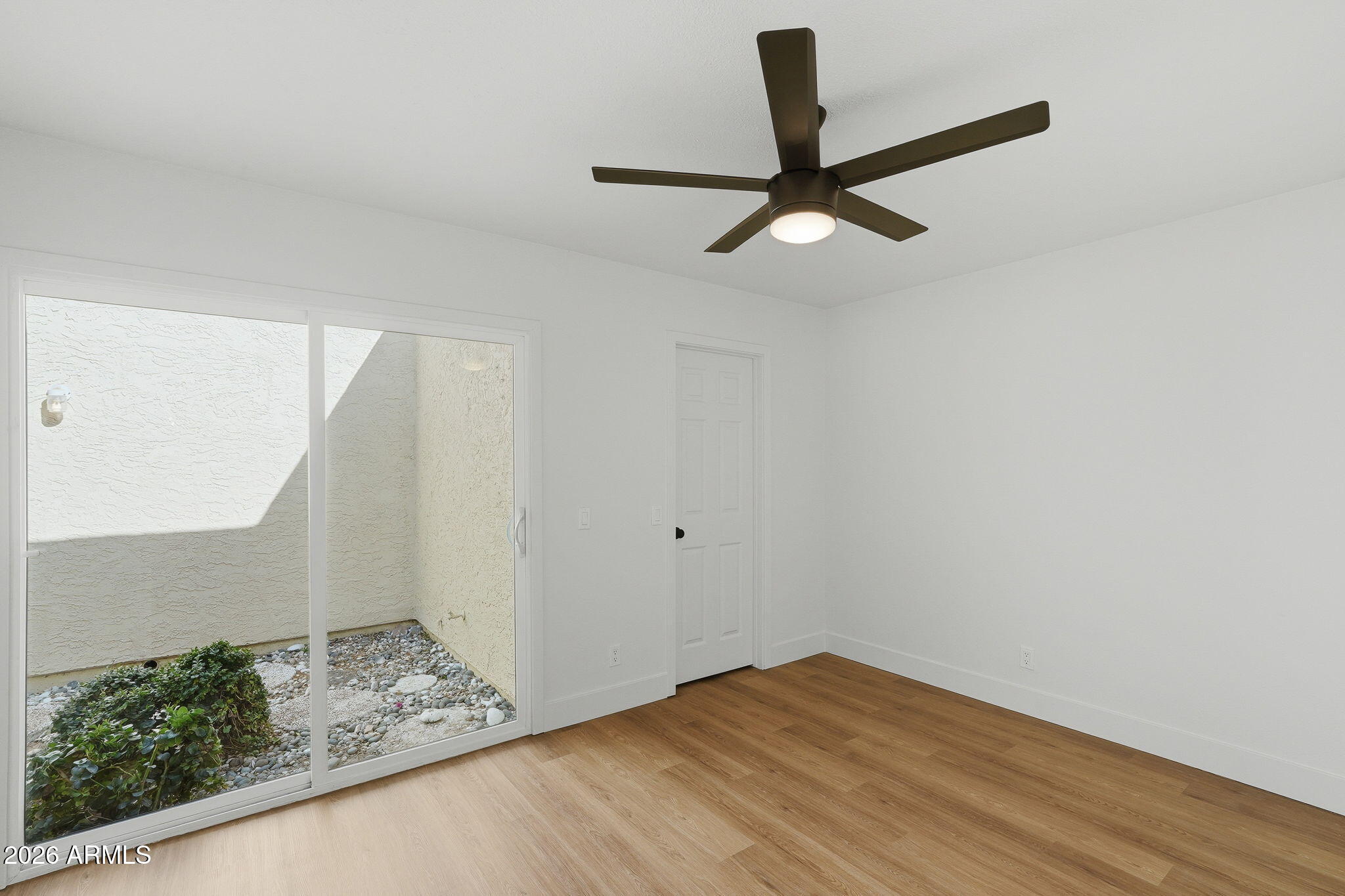 3011 West Sierra Street Phoenix, AZ 85029 - Photo 25 of 35 a view of empty room with wooden floor and ceiling fan