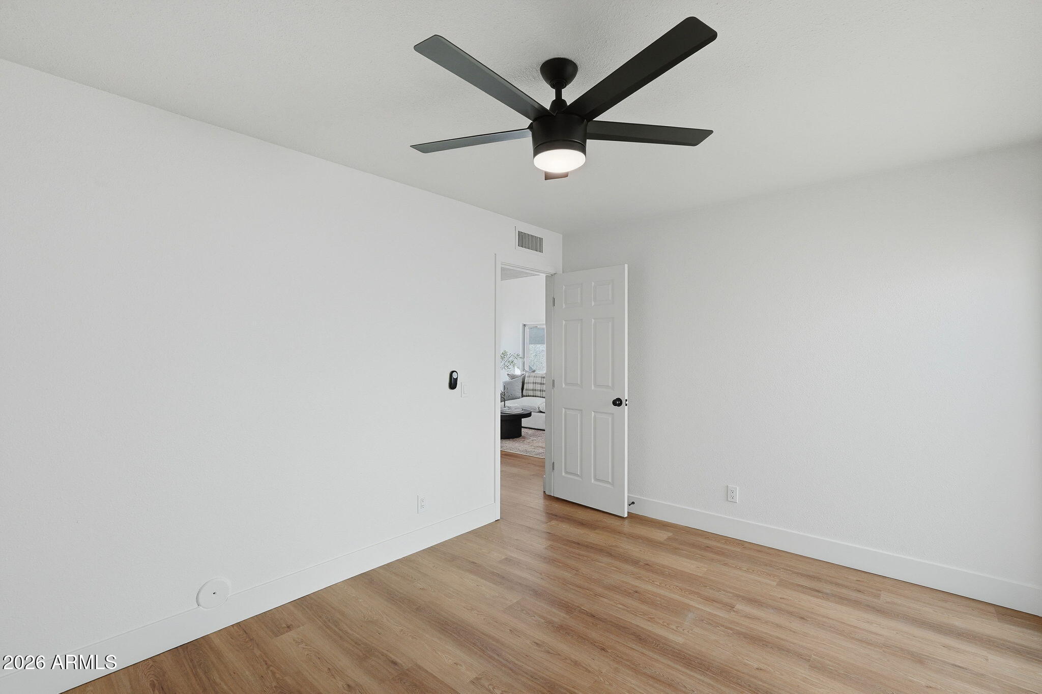 3011 West Sierra Street Phoenix, AZ 85029 - Photo 26 of 35 an empty room with wooden floor and ceiling fan