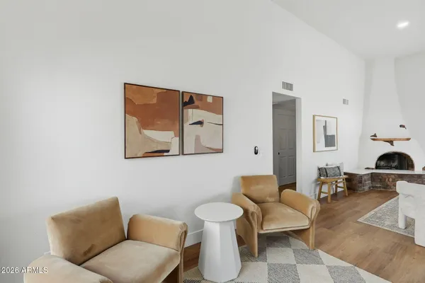 a living room with furniture and a view of kitchen