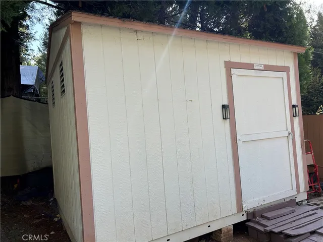 a view of a patio with table and chairs under an umbrella