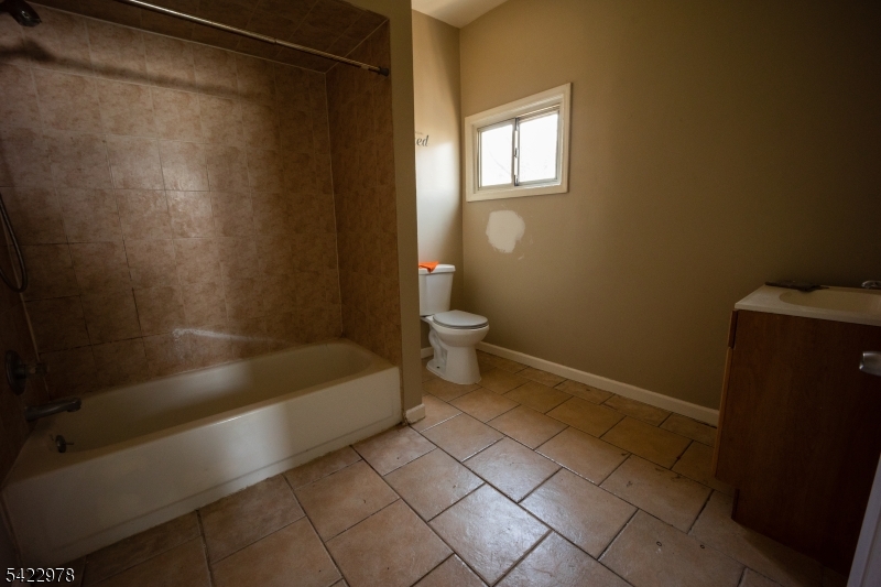 99 North 3rd Street Paterson, NJ 07522 - Photo 17 of 18 a bathroom with a bathtub and a shower