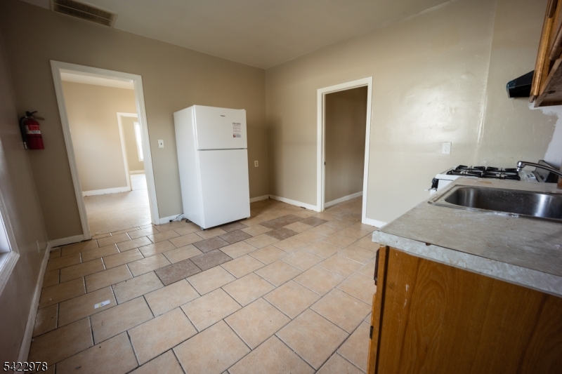 99 North 3rd Street Paterson, NJ 07522 - Photo 18 of 18 a kitchen with a sink and a refrigerator