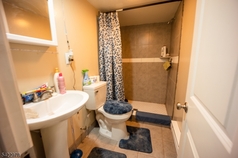 99 North 3rd Street Paterson, NJ 07522 - Photo 5 of 18 a bathroom with a sink toilet and shower