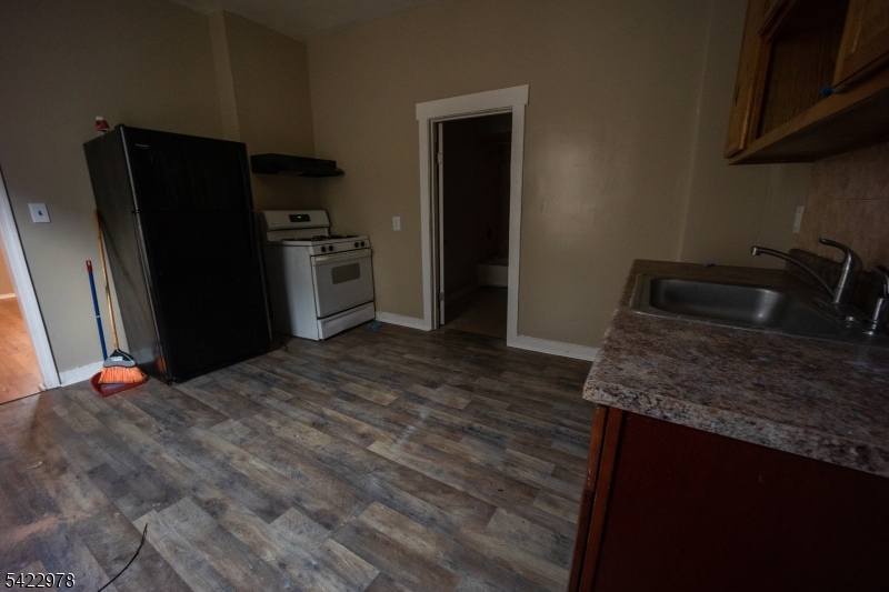 99 North 3rd Street Paterson, NJ 07522 - Photo 9 of 18 a kitchen with granite countertop a refrigerator sink and stove