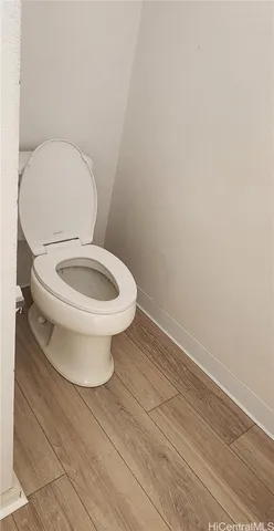 a white toilet sitting next to a white sink