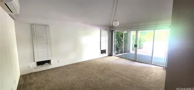 a view of a livingroom with a chandelier fan and window