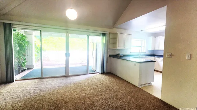 a view of a kitchen with a sink and dishwasher with wooden floor