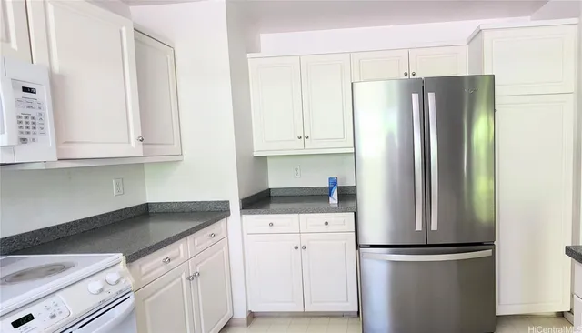 a kitchen with stainless steel appliances granite countertop a refrigerator and a stove