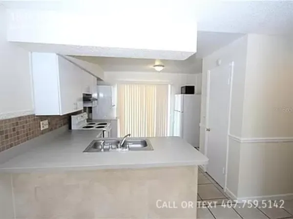 a kitchen with a sink and a refrigerator