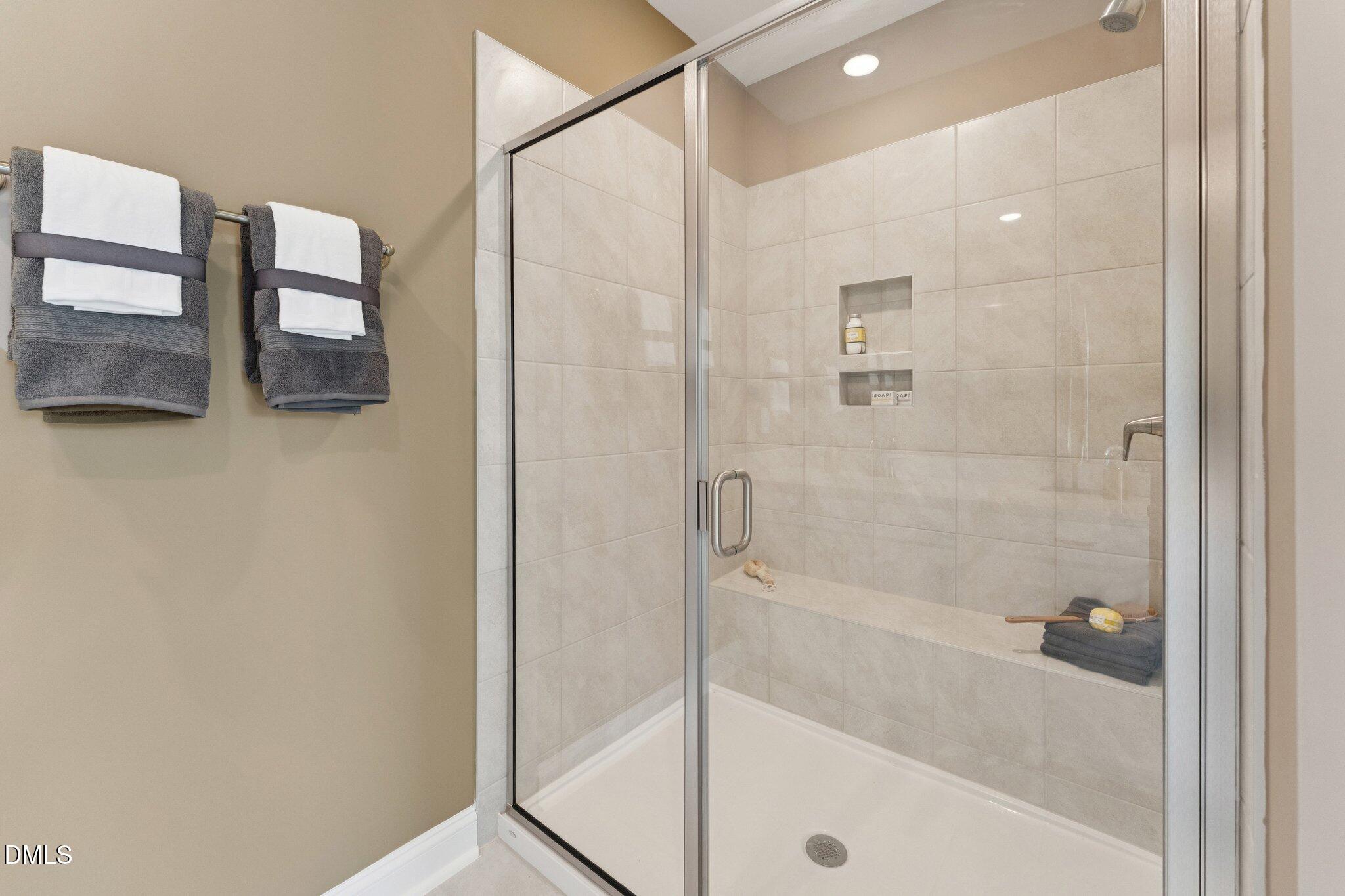 10604 Pleasant Branch Drive Raleigh, NC 27614 - Photo 16 of 40 a bathroom with a shower and a bath tub