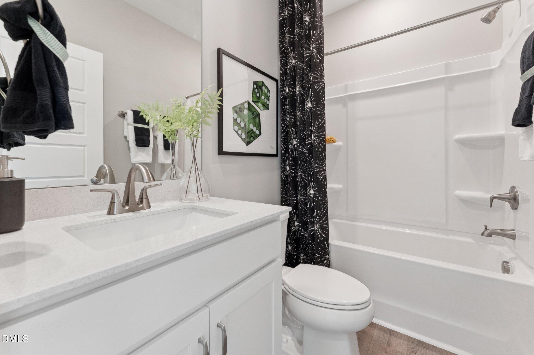 10604 Pleasant Branch Drive Raleigh, NC 27614 - Photo 20 of 40 a bathroom with a sink toilet and shower