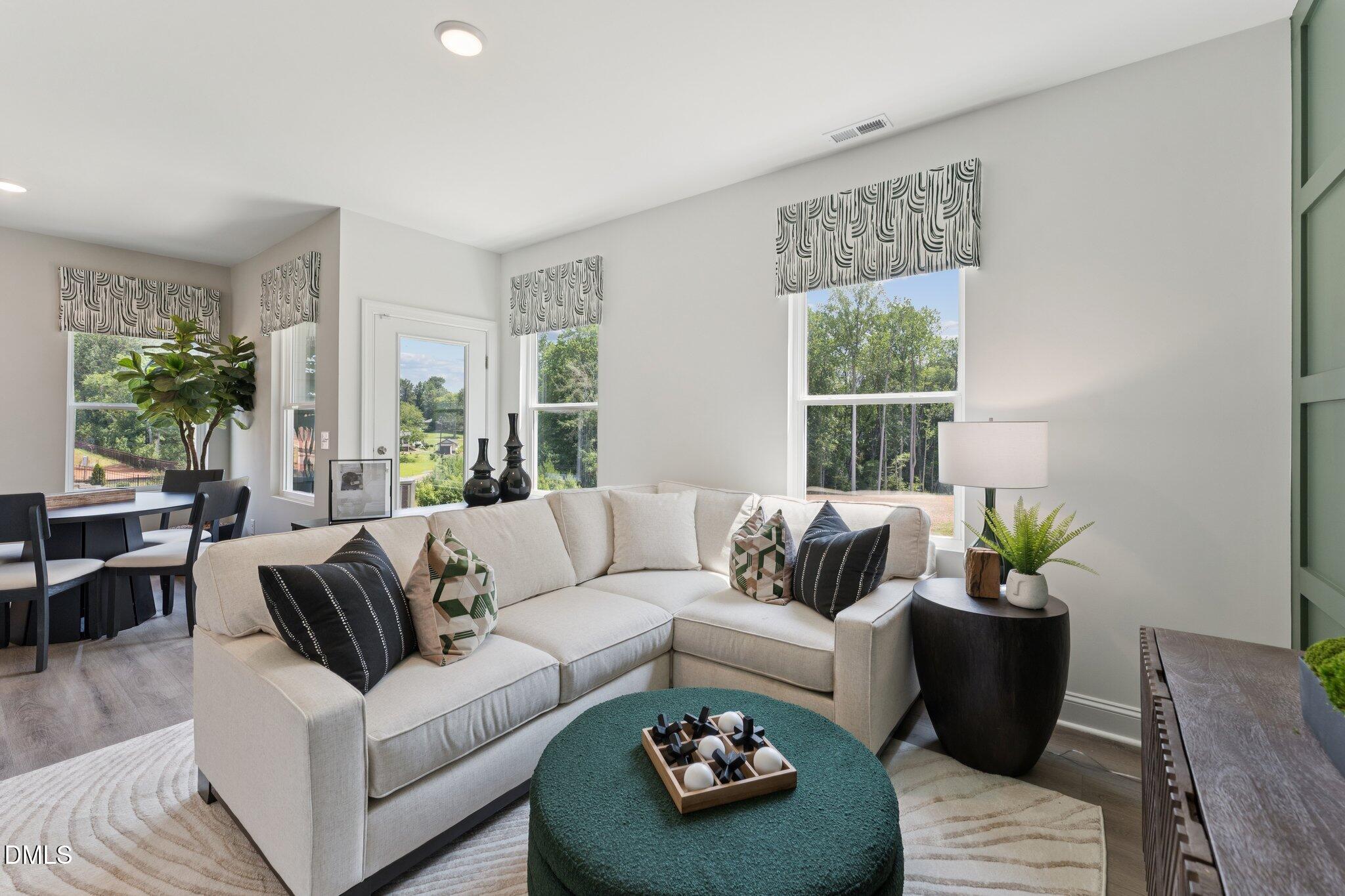 10604 Pleasant Branch Drive Raleigh, NC 27614 - Photo 22 of 40 a living room with furniture and a potted plant