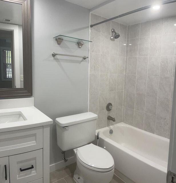 1638 Embassy Drive, Unit 102 West Palm Beach, FL 33401 - Photo 11 of 18 a bathroom with a sink a toilet and a bathtub