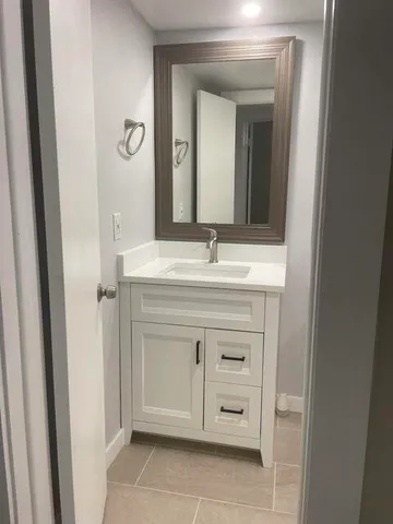 a bathroom with a sink vanity and mirror