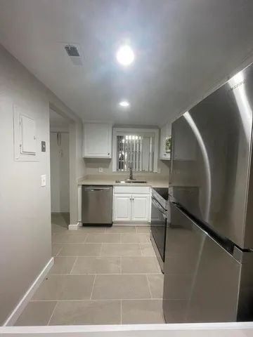 a kitchen with a sink stainless steel appliances and cabinets