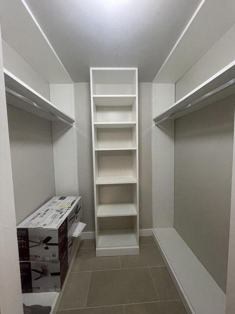 1638 Embassy Drive, Unit 102 West Palm Beach, FL 33401 - Photo 9 of 18 a view of a room with shelves