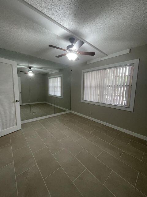 1638 Embassy Drive, Unit 102 West Palm Beach, FL 33401 - Photo 10 of 18 a view of an empty room with a window