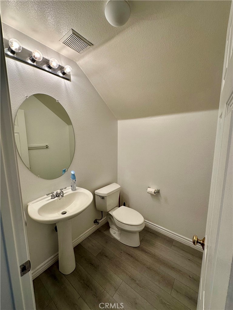 11146 Gardenhurst Court Riverside, CA 92505 - Photo 6 of 16 a bathroom with a sink toilet and mirror