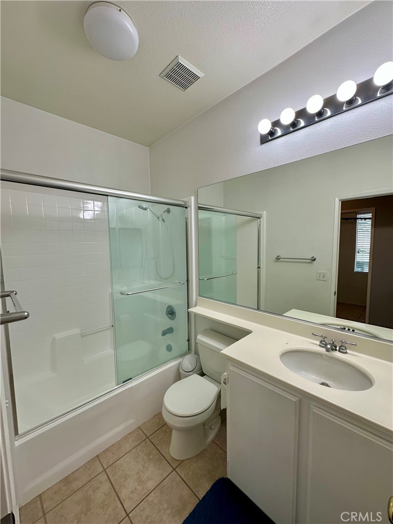 11146 Gardenhurst Court Riverside, CA 92505 - Photo 10 of 16 a bathroom with a sink a toilet and shower