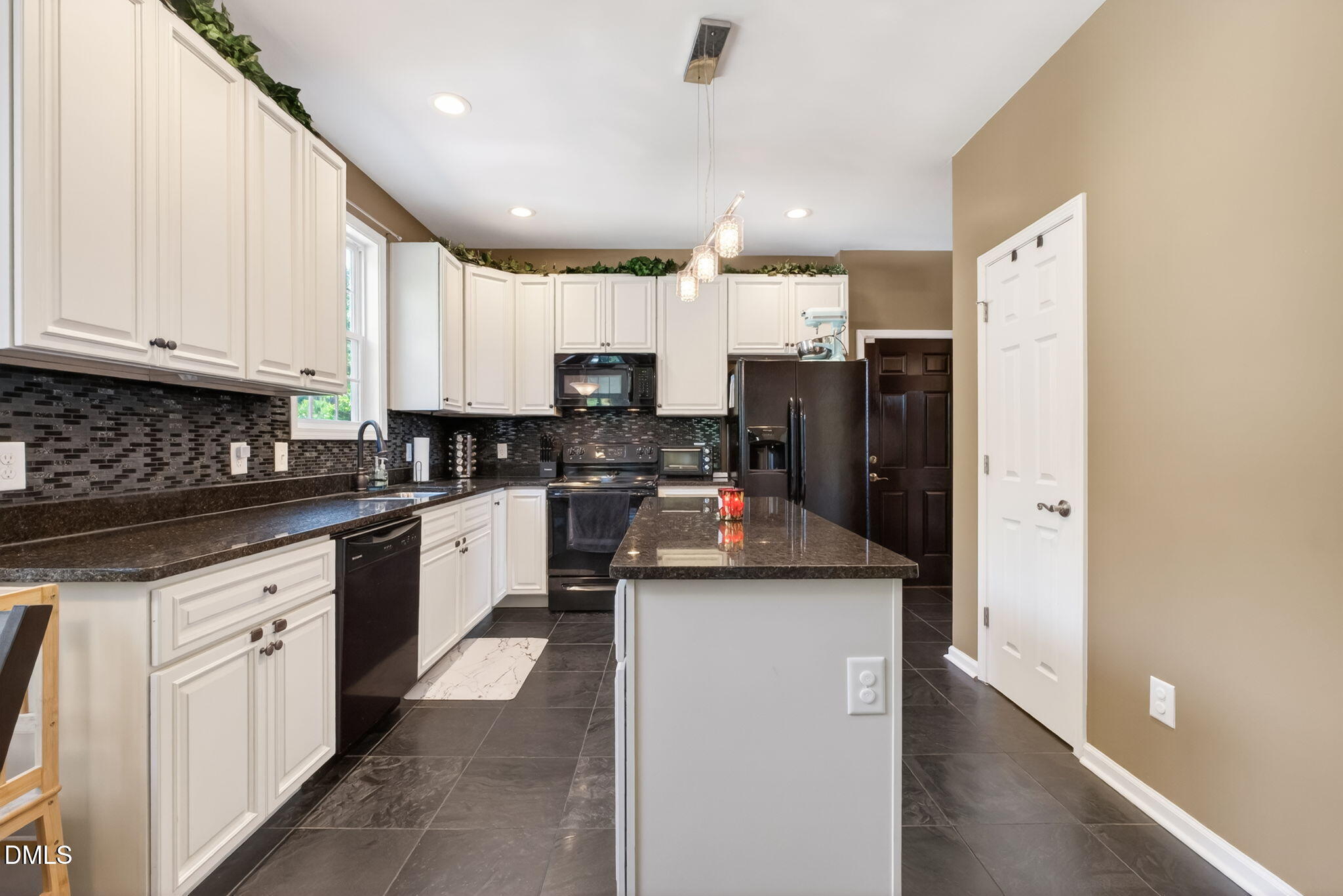 923 White Memorial Church Road Willow Spring, NC 27592 - Photo 20 of 46 a kitchen with stainless steel appliances granite countertop a refrigerator sink stove and white cabinets