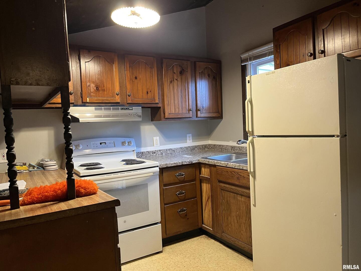 1802 Camanche Avenue Clinton, IA 52732 - Photo 12 of 17 a kitchen with a refrigerator sink and cabinets