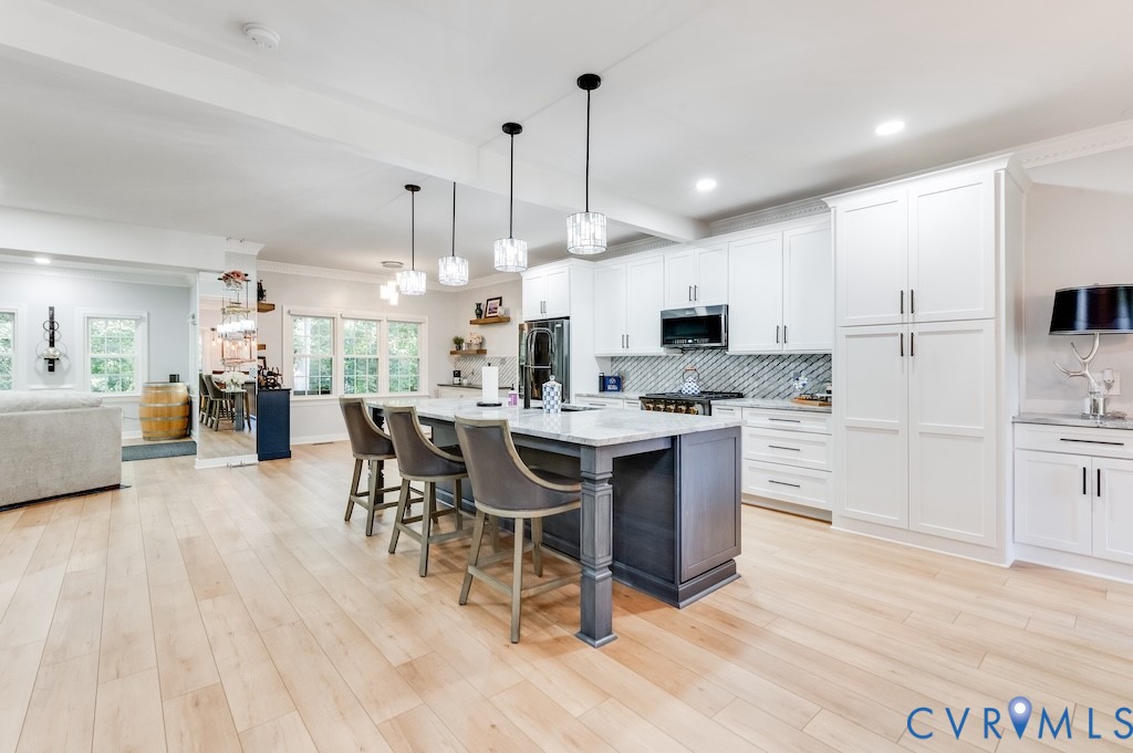 11802 Glendevon Road Chesterfield, VA 23838 - Photo 18 of 47 a kitchen with stainless steel appliances kitchen island granite countertop a table chairs sink and cabinets