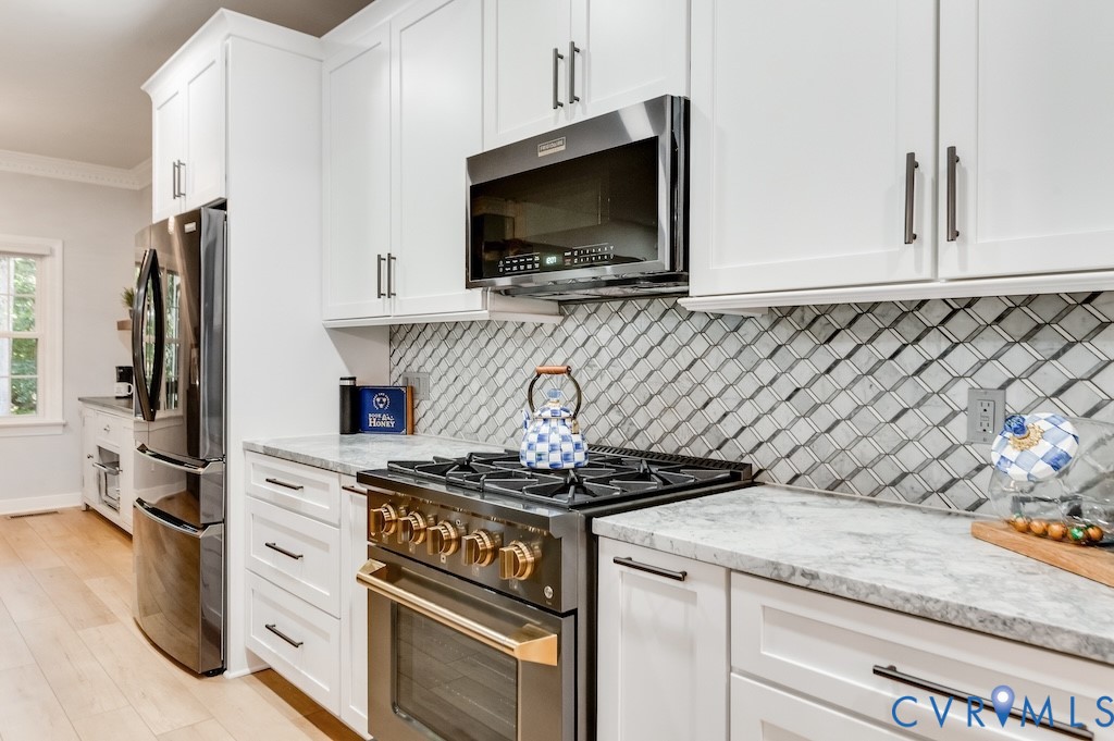 11802 Glendevon Road Chesterfield, VA 23838 - Photo 21 of 47 a kitchen with granite countertop a stove and a microwave