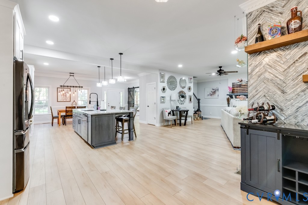 11802 Glendevon Road Chesterfield, VA 23838 - Photo 22 of 47 a living room with stainless steel appliances kitchen island granite countertop furniture a rug kitchen view and a faucet