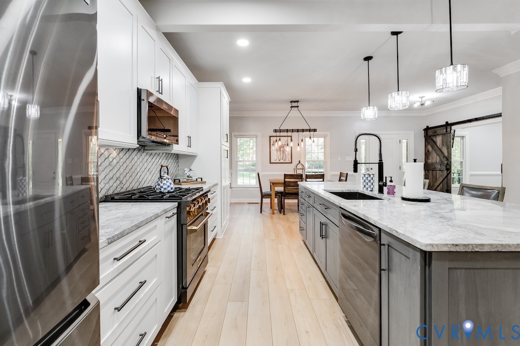 11802 Glendevon Road Chesterfield, VA 23838 - Photo 23 of 47 a large kitchen with stainless steel appliances kitchen island granite countertop a sink a stove and a wooden floors