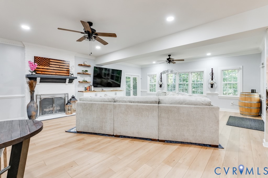 11802 Glendevon Road Chesterfield, VA 23838 - Photo 29 of 47 a living room with furniture a fireplace and a flat screen tv