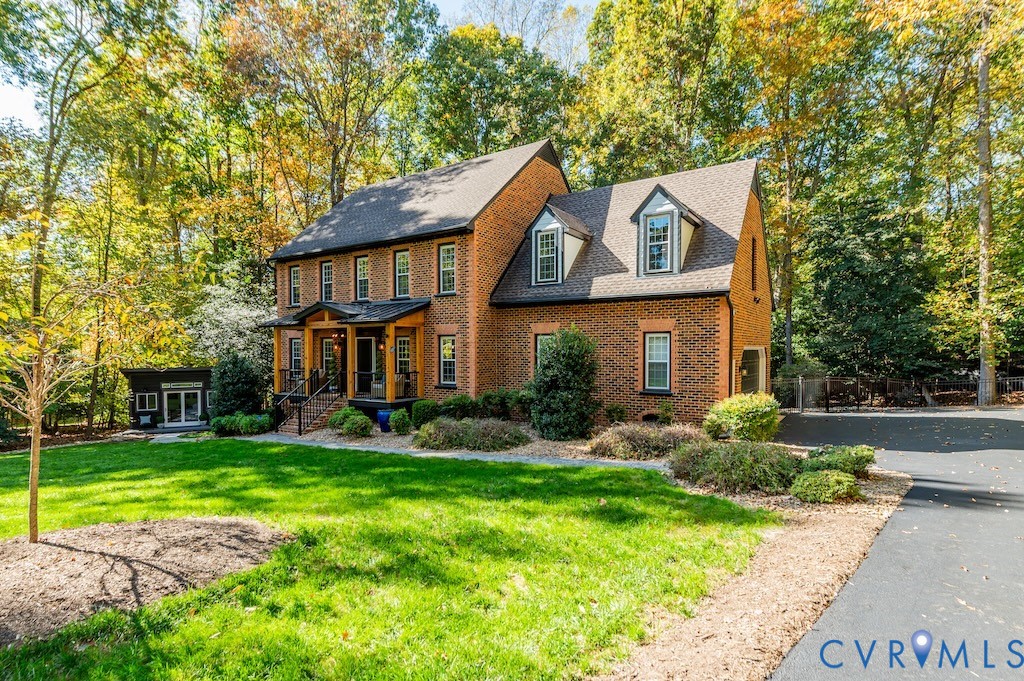 11802 Glendevon Road Chesterfield, VA 23838 - Photo 3 of 47 a view of a brick house with a big yard plants and large trees