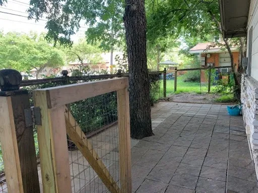 a view of a porch with furniture and a yard